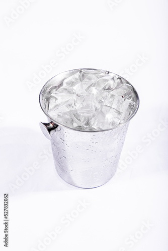 iron cubes of water in stainless steel ice bucket on a white background Ice for cold drinks