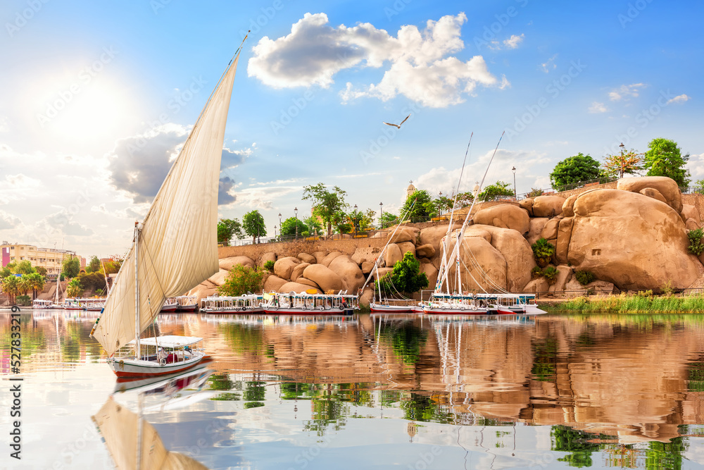 The boat is sailing by the Picturesque banks of the Nile and traditional buildings of Aswan, Egypt