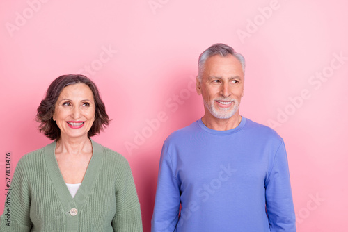 Photo of two cheerful partners toothy smile look interested empty space isolated on pink color background