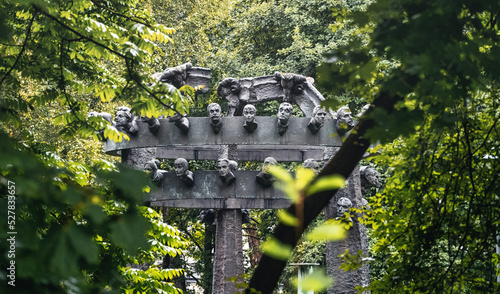 Bronislaw Chromy Gallery Monument with several human faces surround with greenery or trees located in Decius park in Krakow Poland photo