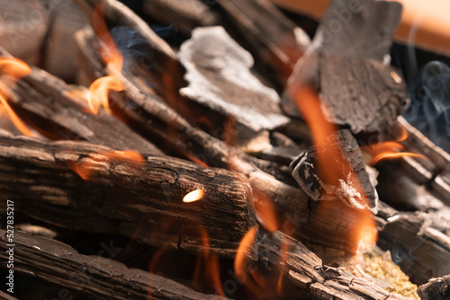 Burning wooden firewood close-up. tongues of flame. background texture fire