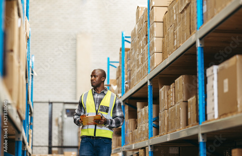 Warehouse supervisor taking inventory in a large logistics centre photo