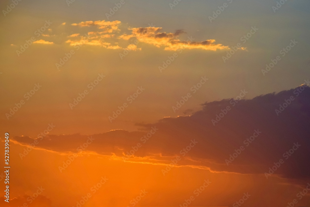 Magnificent bright colorful sky at sunset, nature landscape. Sun's rays break through clouds. Copy space. Soft focus