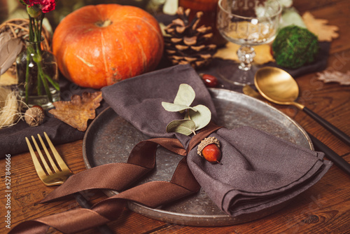 Served table with autumn decor. Thanksgiving dinner table setting