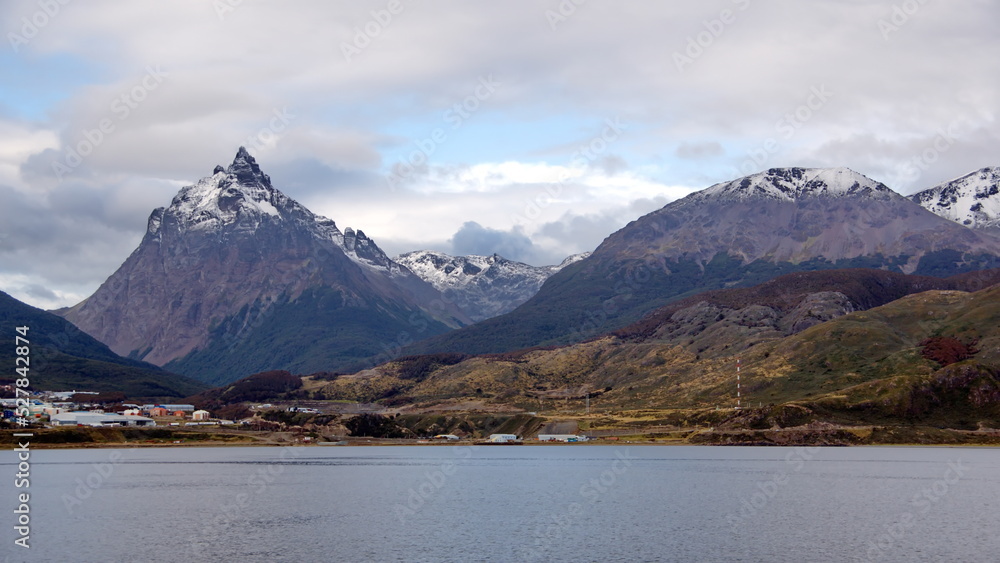 Snow capped Martial Mountains above the outskirts of Ushuaia, Argentina, with the Beagle Channel in the foreground