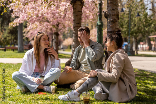 Carefree students spending time in park and enjoying in beautiful spring time