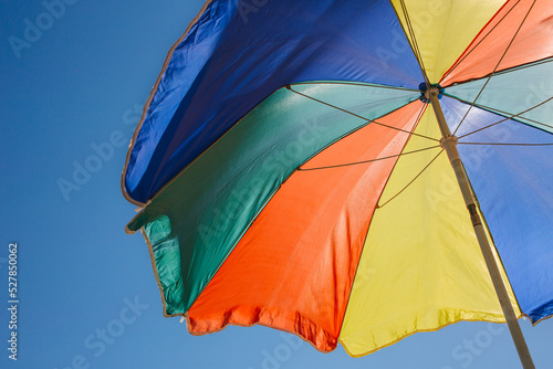 Bottom view of an old vintage umbrella on a sunny day at the beach.