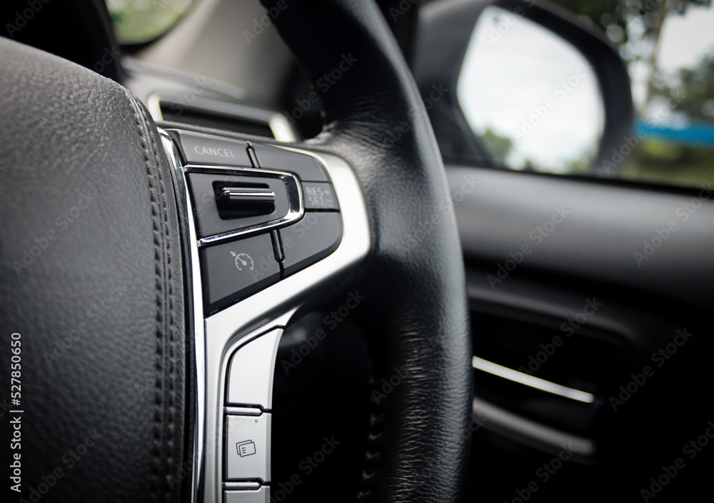 A modern feature in the car is the adaptive cruise control button on ...