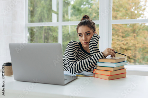 A female student is tired of studying at home. Freelance young woman need a rest from remotely work