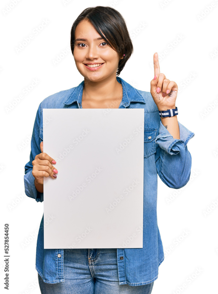 Beautiful young woman with short hair holding blank empty banner surprised with an idea or question pointing finger with happy face, number one Beautiful young woman with short hair holding blank empty banner surprised with an idea or question pointing finger with happy face, number one