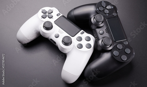 Two video game controllers, joysticks for game console isolated on black background. Gamer controlling devices close-up