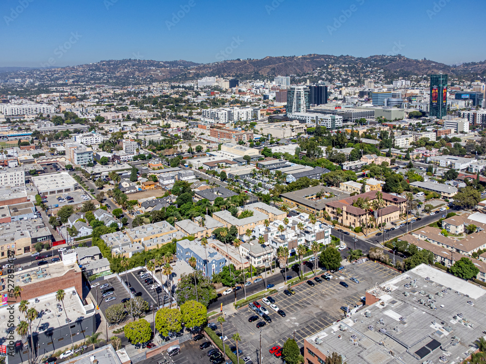 Hollywood, California, USA – August 30, 2022: Aerial Drone View around Sunset Blvd and Highland Ave with Hollywood Walk of Fame, Hollywood Blvd, and the Mountain with Hollywood Sign