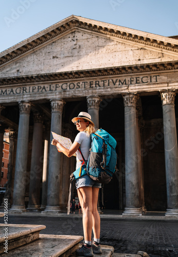 Canvas Print vertical shot of Young woman holds her map of Rome to discover the city and get
