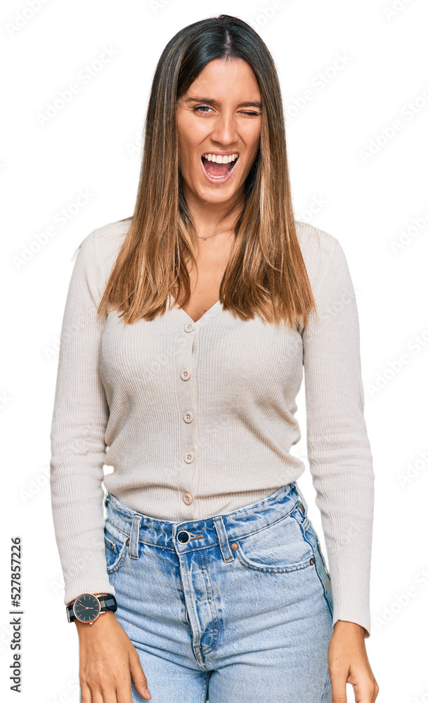 Young woman wearing casual clothes winking looking at the camera with sexy expression, cheerful and happy face. Young woman wearing casual clothes winking looking at the camera with sexy expression, cheerful and happy face.