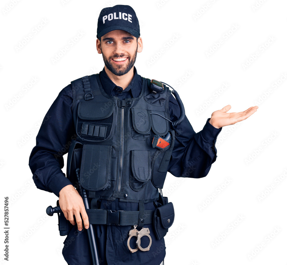 Young handsome man with beard wearing police uniform smiling cheerful presenting and pointing with palm of hand looking at the camera. Young handsome man with beard wearing police uniform smiling cheerful presenting and pointing with palm of hand looking at the camera.