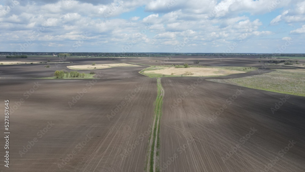 Fototapeta premium Aerial top view photo from flying drone of a land with down fields in countryside.