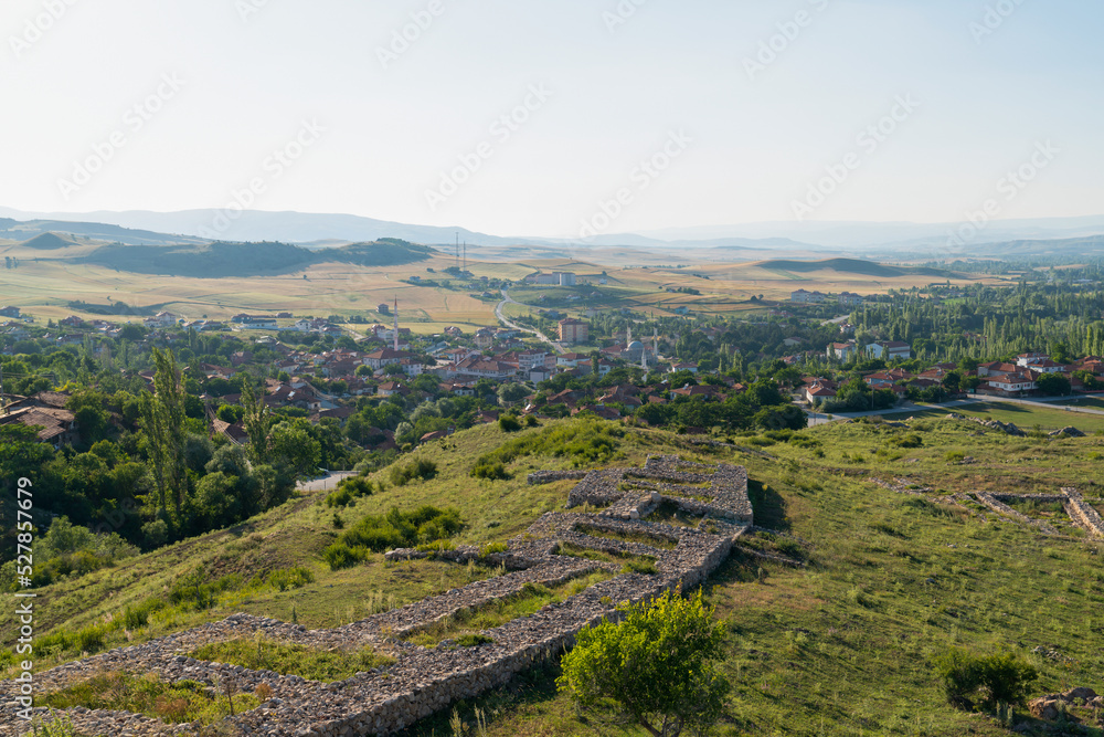 General view of Hattusa was the capital of the Hittite Empire with some stone structures and modern Bogazkale town in background. Corum, Turkey.