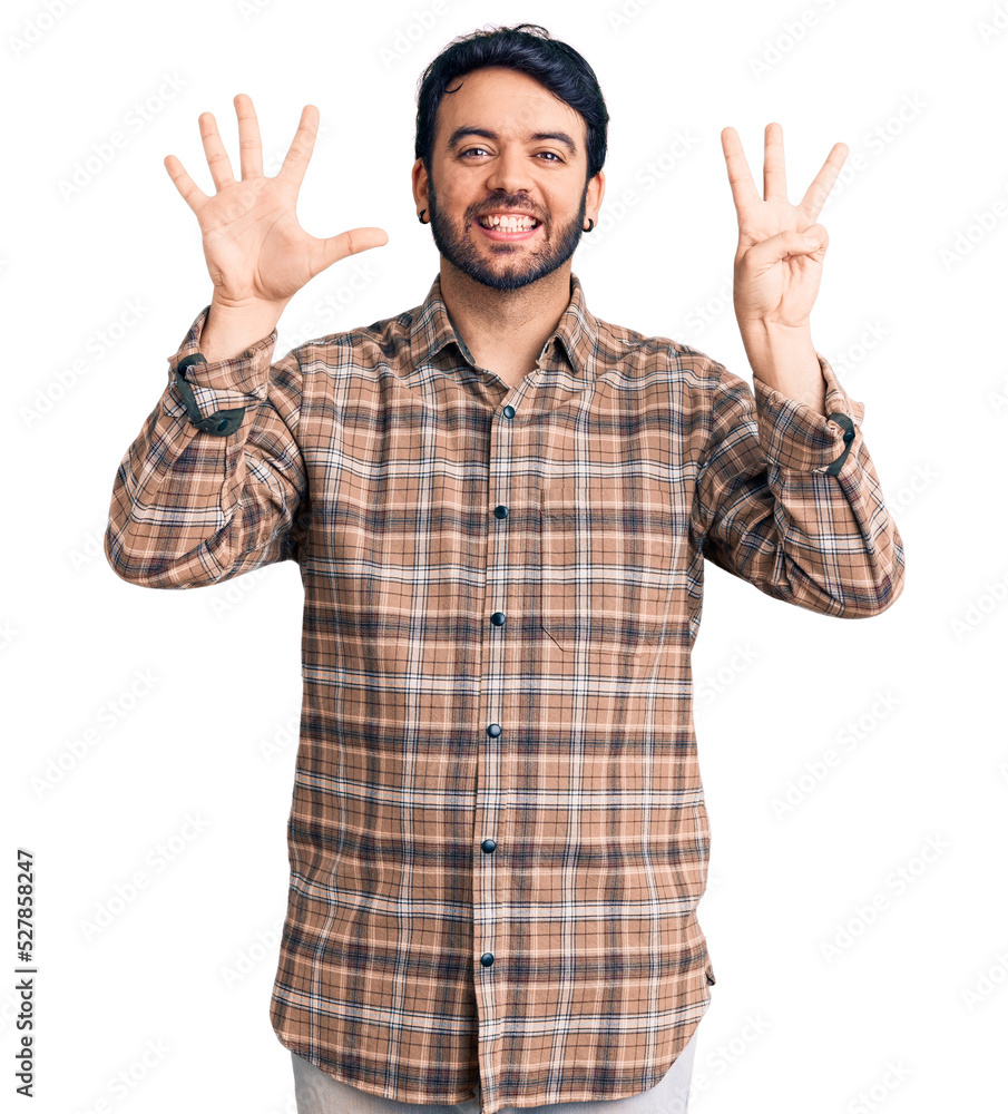 Young hispanic man wearing casual clothes showing and pointing up with fingers number eight while smiling confident and happy. Young hispanic man wearing casual clothes showing and pointing up with fingers number eight while smiling confident and happy.