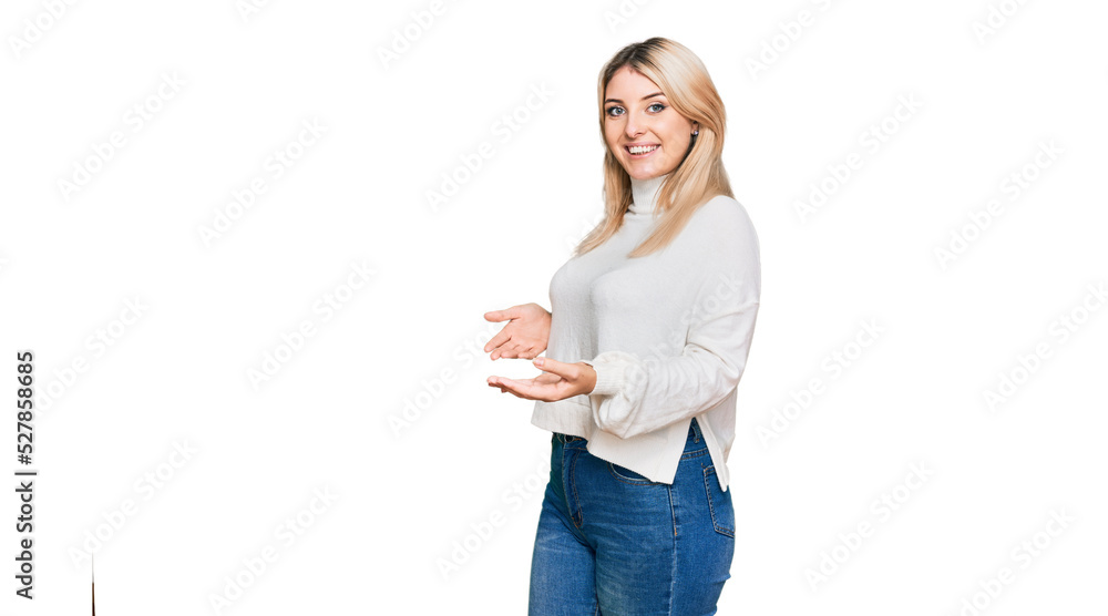 Young caucasian woman wearing casual winter sweater inviting to enter smiling natural with open hand