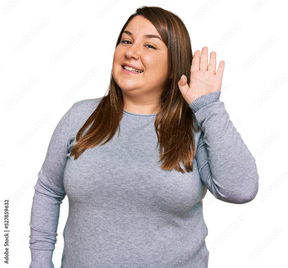 Beautiful brunette plus size woman wearing casual clothes waiving saying hello happy and smiling, friendly welcome gesture Beautiful brunette plus size woman wearing casual clothes waiving saying hello happy and smiling, friendly welcome gesture