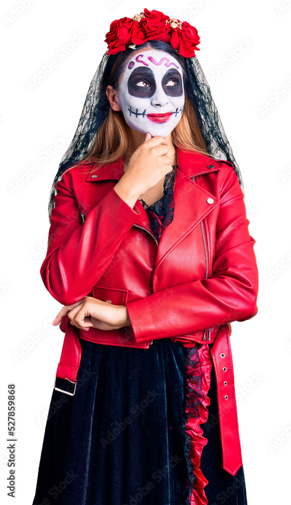 Woman wearing day of the dead costume over background with hand on chin thinking about question, pensive expression. smiling with thoughtful face. doubt concept.