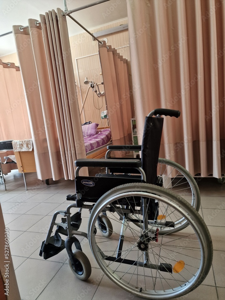 a wheelchair for transporting patients is in the intensive care unit of the hospital
