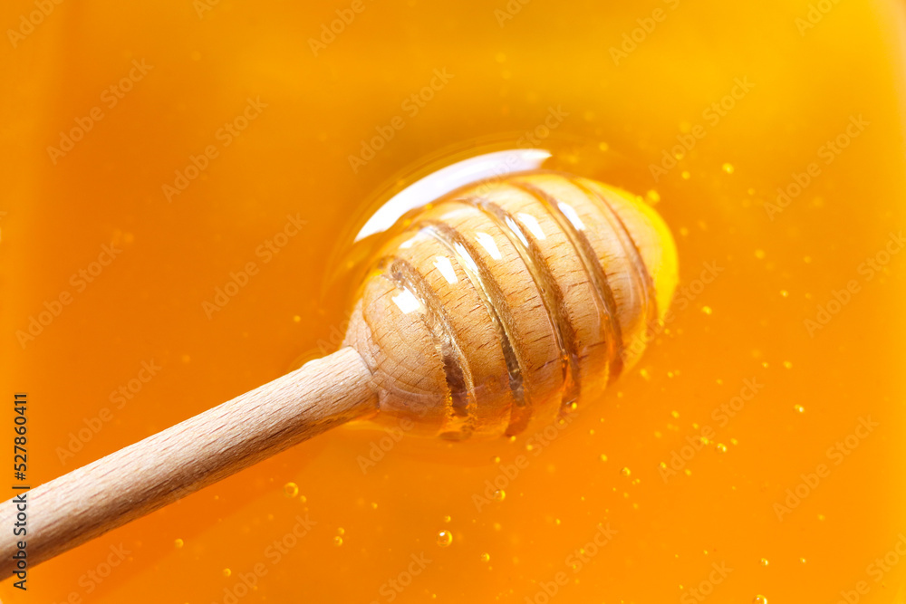 Texture of natural golden honey with air bubbles as a background. Wooden honey dipper ( spoon ). Free space for text. Texture of natural golden honey with air bubbles as a background. Wooden honey dipper ( spoon ). Free space for text.