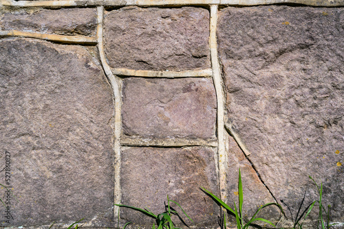 Stonewall textured background - large quarried blocks of stone combine into patterns of an exterior wall. 