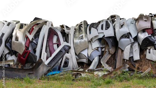 Obraz na plátne Isolated pieces of front bumper scraps, which were collected from the garage and dumped on grassy ground