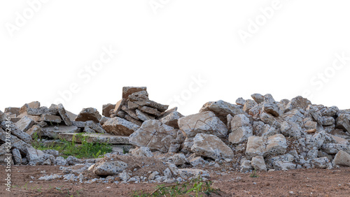 Many of the concrete debris is damaged by the removal of old roads that have been left on the ground and grass growing.