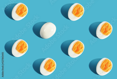 Difference pattern slice boiled eggs on blue background. Think different concept and business success idea photo