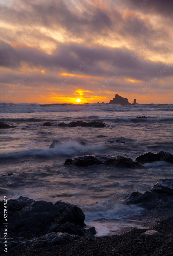 Sunset with sea stacks and a rocky beach at low tide at Rialto Beach in Olympic National Park

