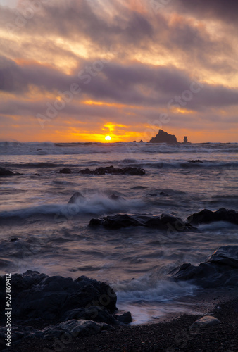 Sunset with sea stacks and a rocky beach at low tide at Rialto Beach in Olympic National Park 