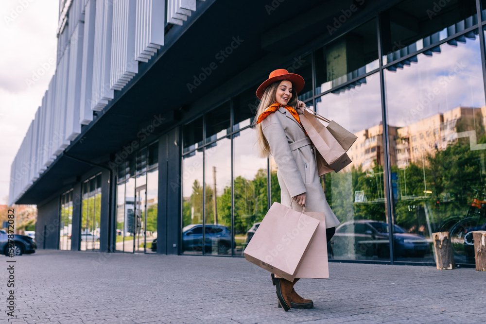 Young attractive woman enjoying a good shopping in the city , with bags in hand Young attractive woman enjoying a good shopping in the city , with bags in hand