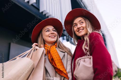 Two young girls shopping in the sunny weather