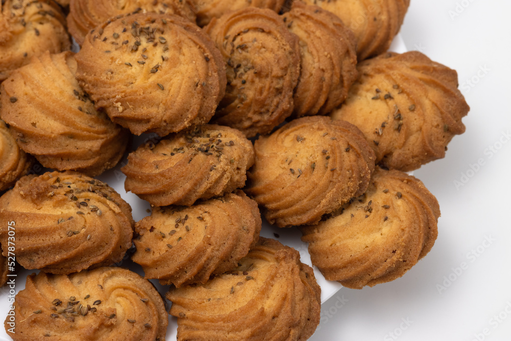 Closeup of Cookies or biscuit stacked on plate for breakfast or snacks, a healthy concept lifestyle with copy space for text isolated on white background Closeup of Cookies or biscuit stacked on plate for breakfast or snacks, a healthy concept lifestyle with copy space for text isolated on white background