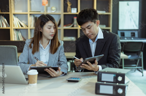 Person analyzing figures, Two businessman working on tablet and new startup marketing idea presentation, Business meeting discussion startup concept. 