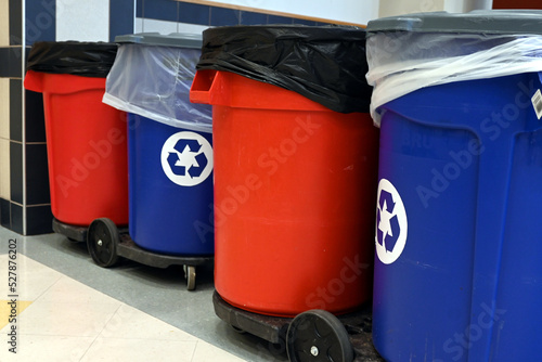 Regular and recycling garbage bins lined up in big building. Custodial cleaning routine in corporate environment