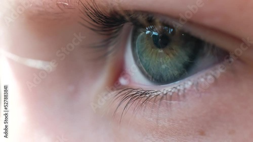 A close-up of a child's eye. A child looking into the far distance. Macro shot