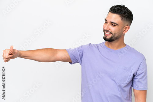 Young Arab handsome man isolated on white background giving a thumbs up gesture