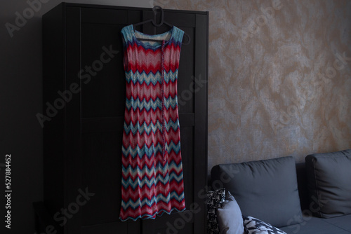 Crocheted missoni pattern of red white and blue threads on the dress photo