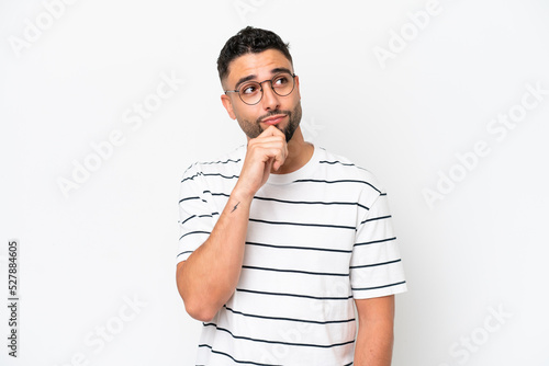 Young Arab handsome man isolated on white background and looking up