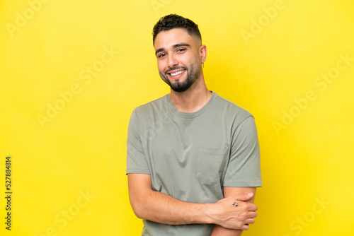 Young Arab handsome man isolated on yellow background laughing © luismolinero