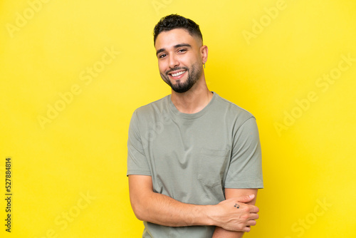 Young Arab handsome man isolated on yellow background laughing