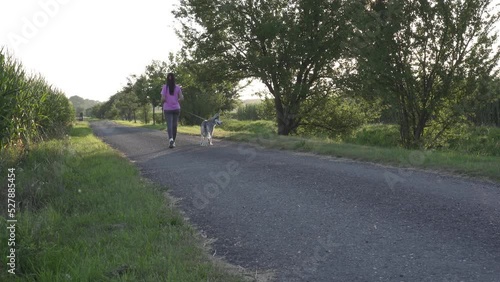 Wallpaper Mural Young woman walking with her husky dog. Love and friendship with dog, domestic animals. Torontodigital.ca