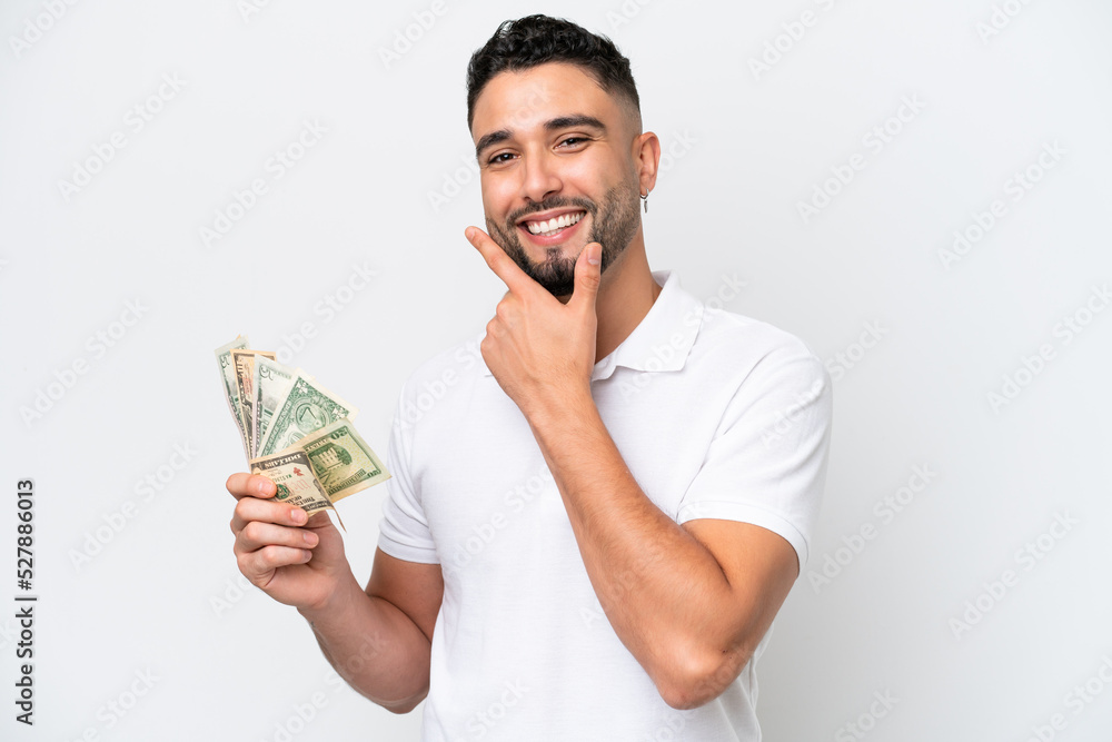 Young Arab man taking a lot of money isolated on white background happy and smiling Young Arab man taking a lot of money isolated on white background happy and smiling