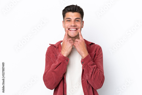 Young caucasian man isolated on white background smiling with a happy and pleasant expression