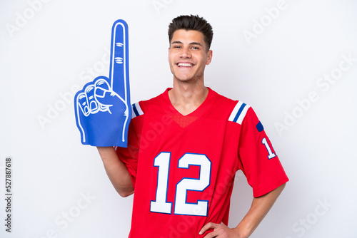 Young caucasian sports fan man isolated on white background posing with arms at hip and smiling