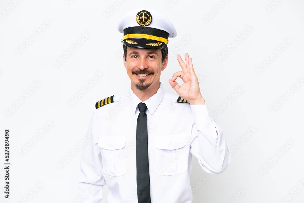 Airplane caucasian pilot isolated on white background showing ok sign with fingers Airplane caucasian pilot isolated on white background showing ok sign with fingers