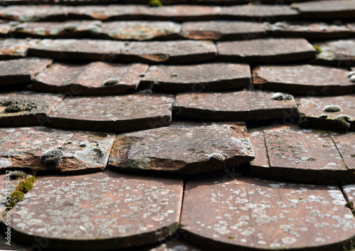 Roofing detail. It is arched and old  dirty and broken.